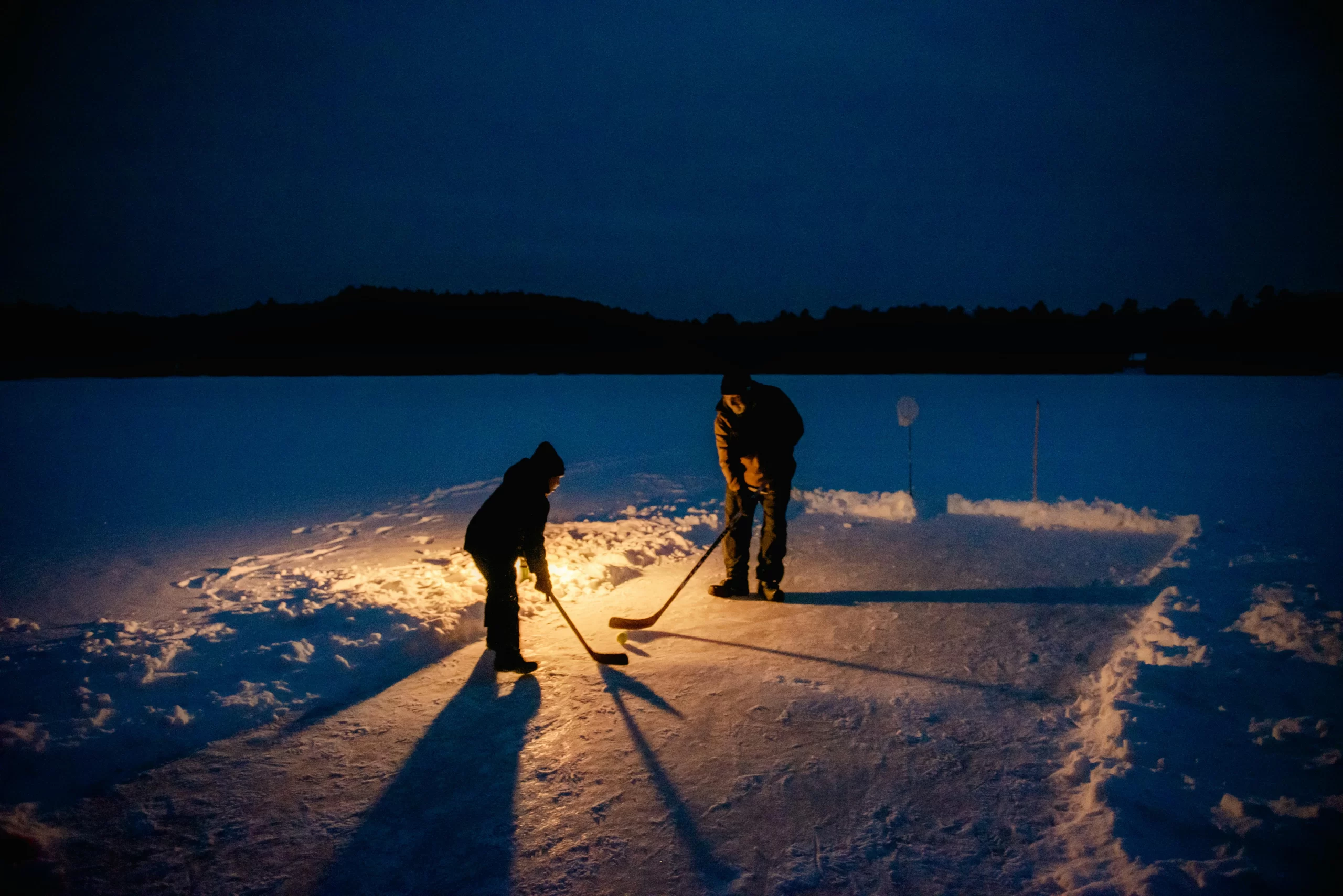 Father and son playing in the snow.