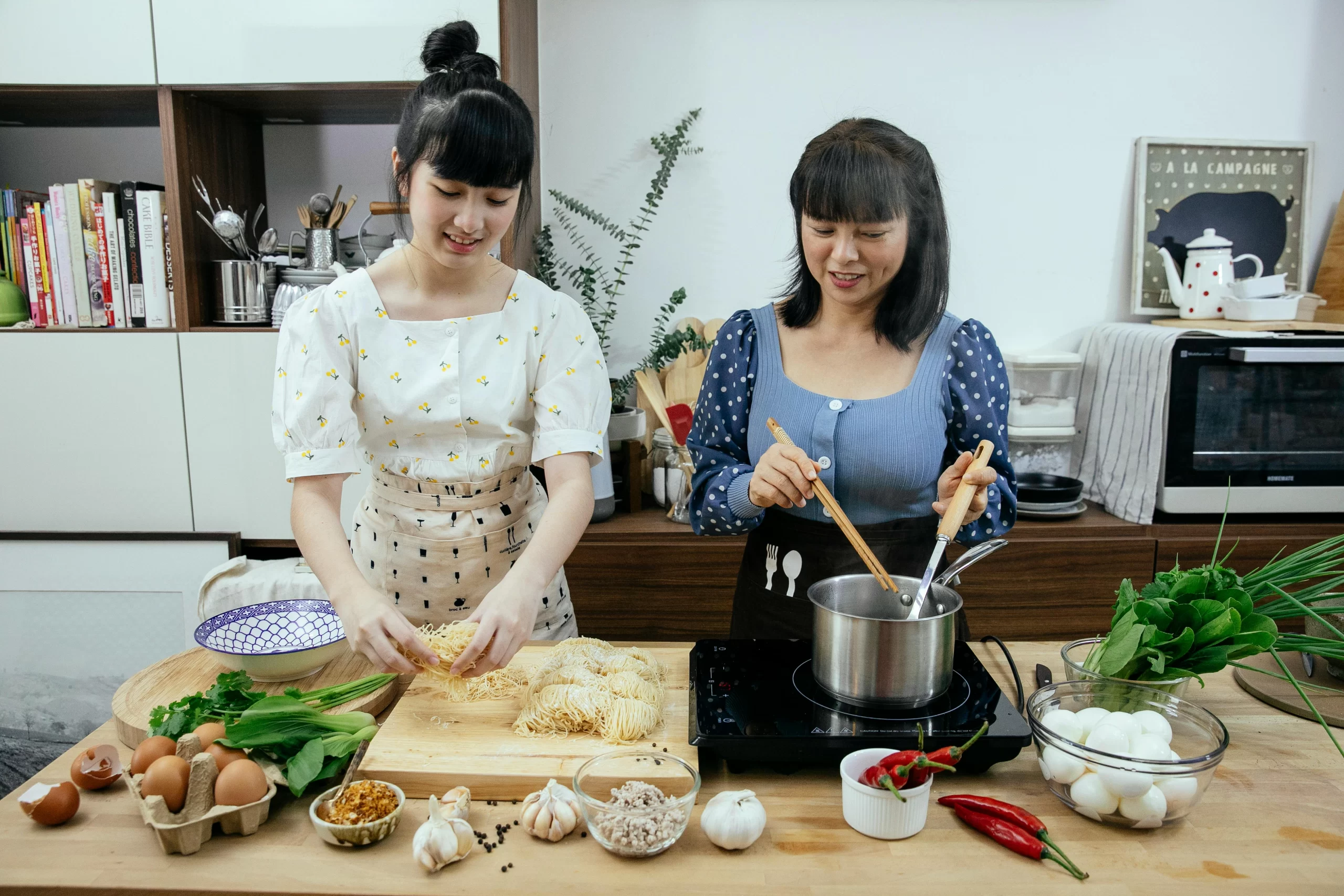 Mother and daughter preparing healthy meals together.