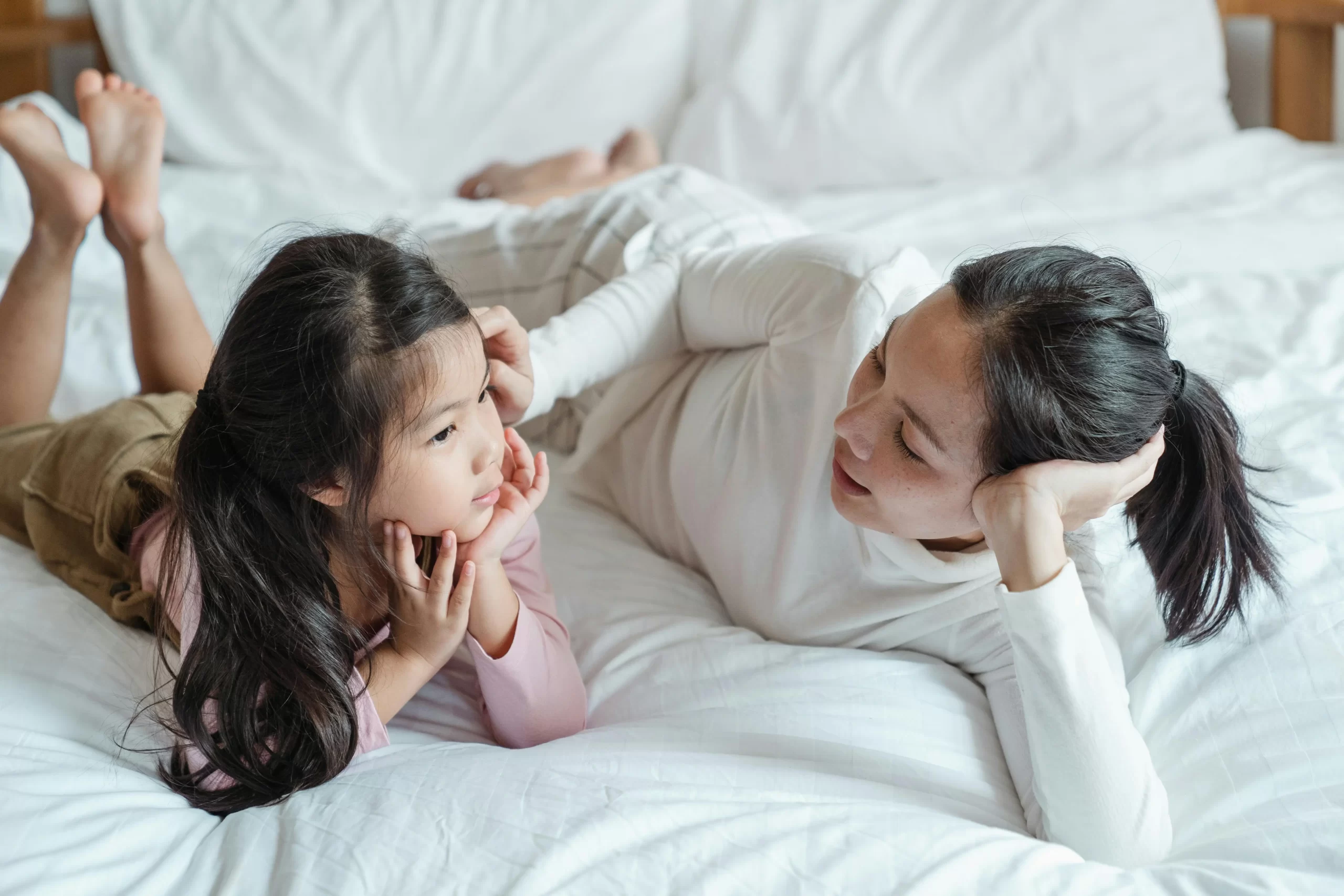 Mother and daughter talking about sports after dinner.