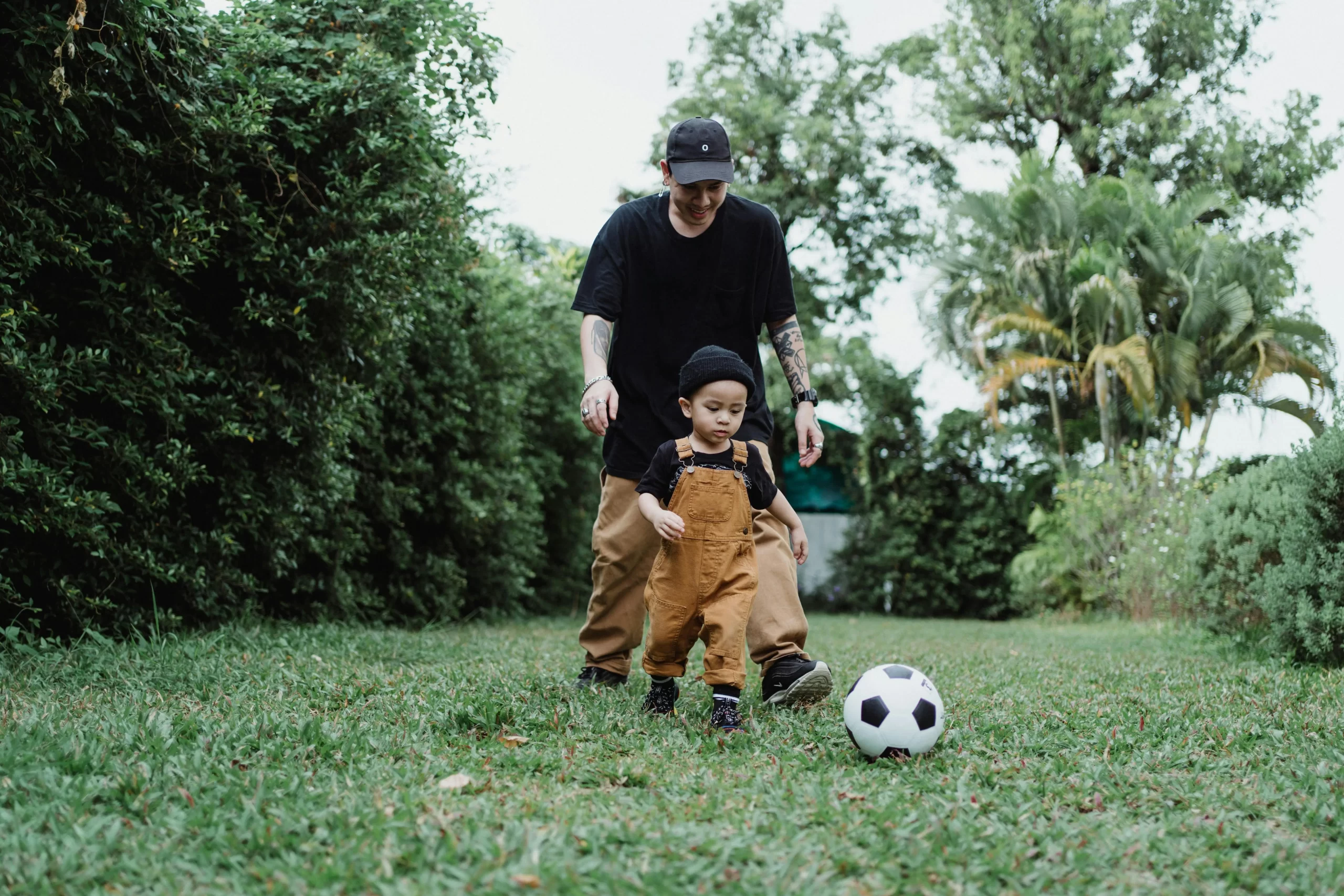 Father cheering on his child during a soccer game, showcasing family support in youth sports.