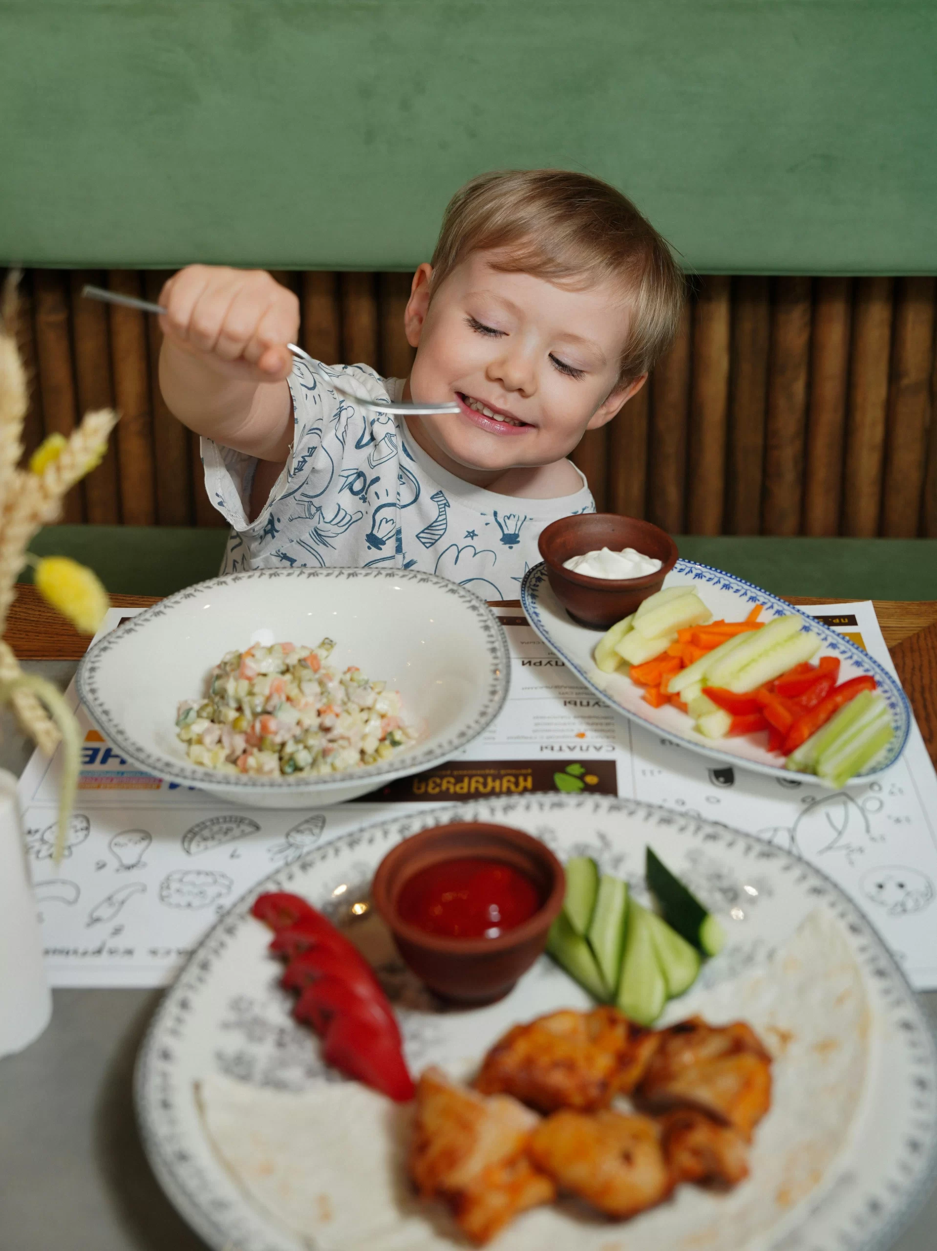 A young child eating healthy meals.