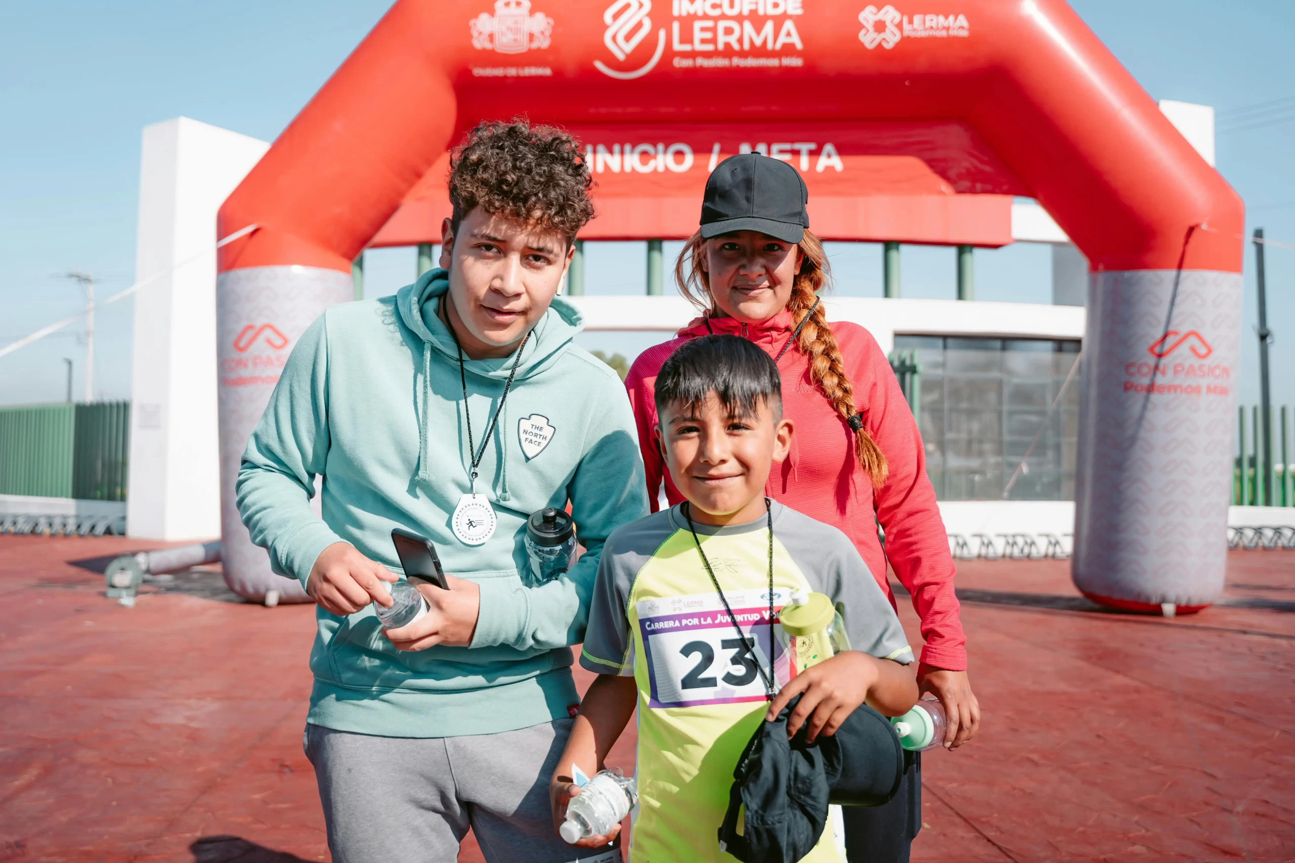 Parent with their young athlete taking pictures after the event.